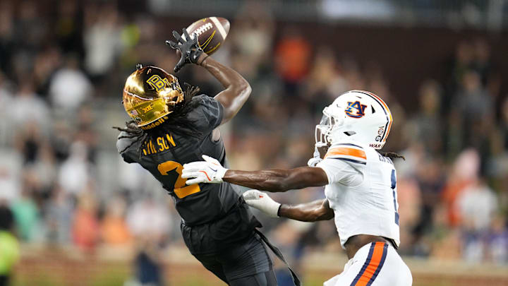Aug 29, 2025; Waco, Texas, USA; Baylor Bears wide receiver Kole Wilson (2) makes a catch against Auburn Tigers safety Champ Anthony (1) during the second half at McLane Stadium. Mandatory Credit: Chris Jones-Imagn Images