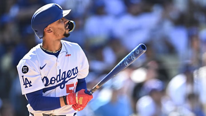Aug 17, 2025; Los Angeles, California, USA; Los Angeles Dodgers shortstop Mookie Betts (50) hits a solo home run against the San Diego Padres during the eighth inning at Dodger Stadium. Mandatory Credit: Jonathan Hui-Imagn Images