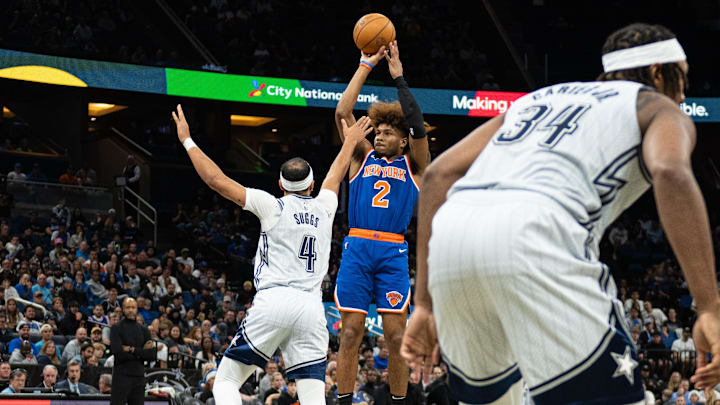 New York Knicks guard Miles McBride (2) shoots the ball over Orlando Magic guard Jalen Suggs (4) in the second quarter at Kia Center.