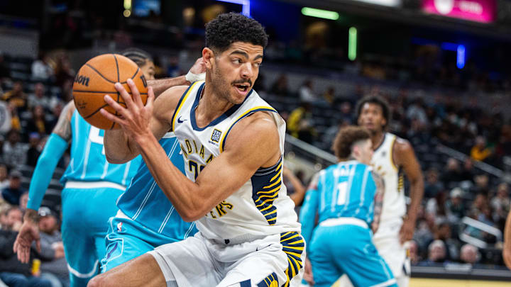 Oct 17, 2024; Indianapolis, Indiana, USA; Indiana Pacers guard Ben Sheppard (26) rebounds the ball  in the first half against the Charlotte Hornets at Gainbridge Fieldhouse. Mandatory Credit: Trevor Ruszkowski-Imagn Images