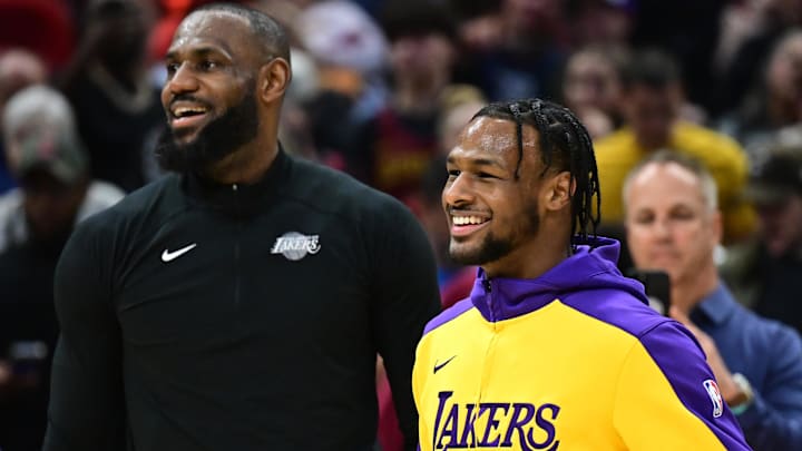Los Angeles Lakers guard Bronny James, right, and forward LeBron James warm up before the game between the Cleveland Cavaliers and the Lakers.