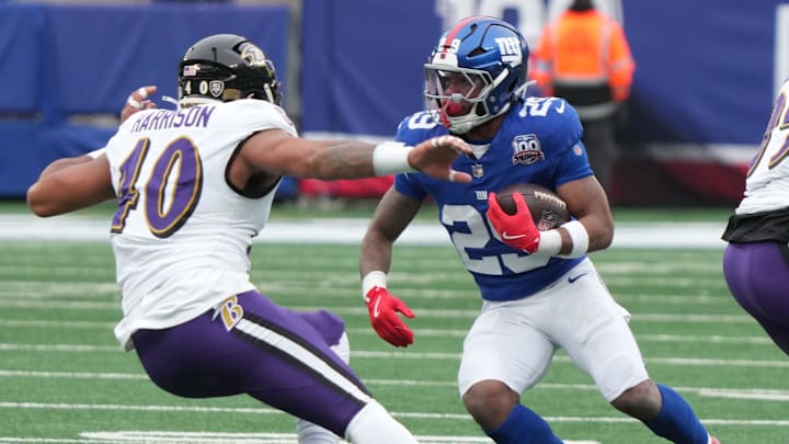 East Rutherford, NJ -- December 15, 2024 -- Malik Harrison of the Ravens and Tyrone Tracy Jr. of the Giants in the first half. The Baltimore Ravens came to MetLife Stadium to play the New York Giants.