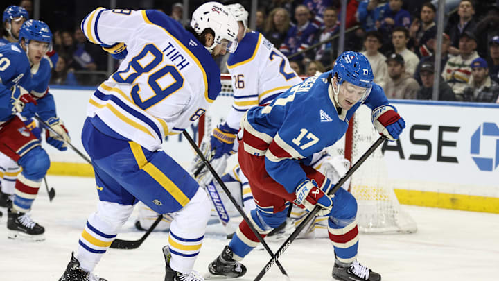 Jan 8, 2026; New York, New York, USA;  Buffalo Sabres right wing Alex Tuch (89) and New York Rangers defenseman Will Borgen (17) battle for control of the puck in the first period at Madison Square Garden. Mandatory Credit: Wendell Cruz-Imagn Images
