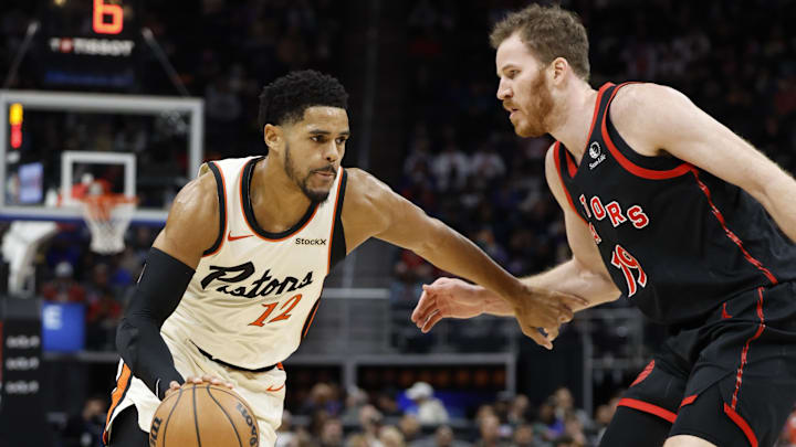 Nov 25, 2024; Detroit, Michigan, USA;  Detroit Pistons forward Tobias Harris (12) dribbles defended by Toronto Raptors center Jakob Poeltl (19) in the first half at Little Caesars Arena. Mandatory Credit: Rick Osentoski-Imagn Images