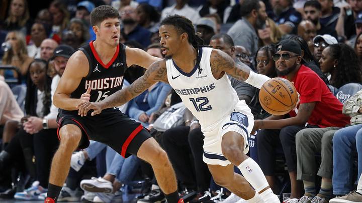 Nov 5, 2025; Memphis, Tennessee, USA; Memphis Grizzlies guard Ja Morant (12) dribbles as Houston Rockets guard Reed Sheppard (15) defends during the fourth quarter at FedExForum. Mandatory Credit: Petre Thomas-Imagn Images