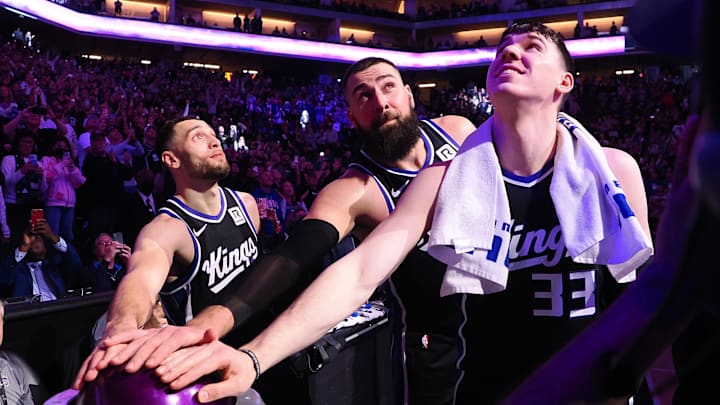 Feb 8, 2025; Sacramento, California, USA; Sacramento Kings guard Zach LaVine (8), center Jonas Valaciunas (17) and forward Jake LaRavia (33) look up after pushing the button to light the beam after a win against the New Orleans Pelicans at Golden 1 Center. Mandatory Credit: Kelley L Cox-Imagn Images