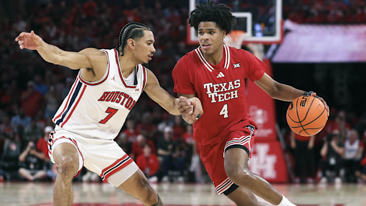 Texas Tech Red Raiders guard Christian Anderson drives with the ball at Houston Cougars guard Milos Uzan. Mandatory Credit: Troy Taormina-Imagn Images