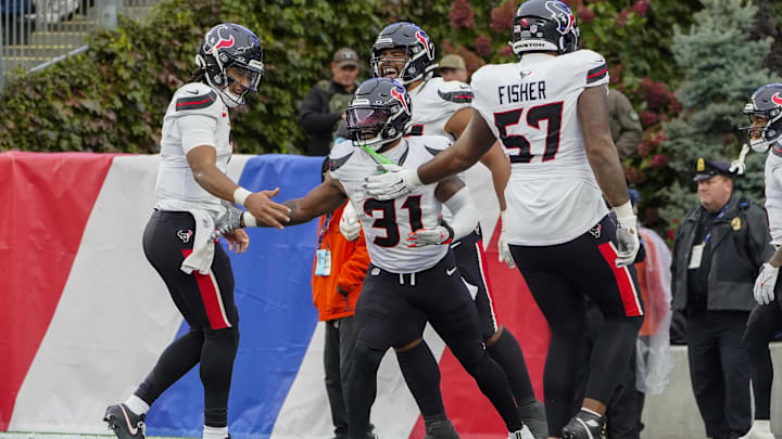 Oct 13, 2024; Foxborough, Massachusetts, USA; Houston Texans quarterback C.J. Stroud (7) and Houston Texans offensive tackle Blake Fisher (57) congratulate Houston Texans running back Dameon Pierce (31) for scoring a touchdown against the New England Patriots during the second half at Gillette Stadium. Mandatory Credit: Gregory Fisher-Imagn Images