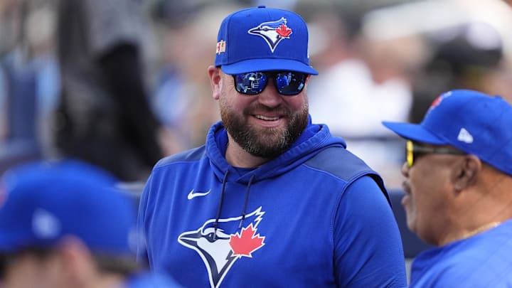 Sep 11, 2025; Toronto, Ontario, CAN; Toronto Blue Jays manager John Schneider smiles in the dugout during the second inning against the Houston Astros at Rogers Centre. 