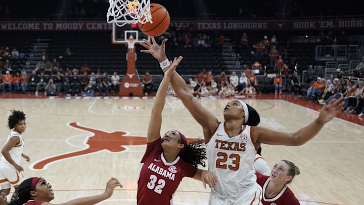 Jan 9, 2025; Austin, Texas, USA; Texas Longhorns forward Aaliyah Moore (23) and Alabama Crimson Tide guard Aaliyah Nye (32) reach for a rebound during the second half at Moody Center. Mandatory Credit: Scott Wachter-Imagn Images