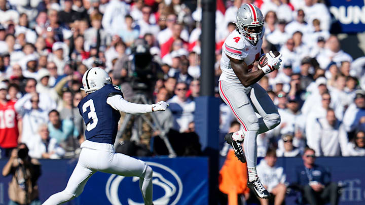 Ohio State Buckeyes wide receiver Jeremiah Smith (4) catches a pass as Penn State Nittany Lions cornerback Jalen Kimber (3) covers. Ohio State Buckeyes wide receiver Jeremiah Smith (4) catches a pass as Penn State Nittany Lions cornerback Jalen Kimber (3) covers.