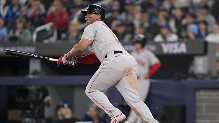 Apr 30, 2025; Toronto, Ontario, CAN; Boston Red Sox designated hitter Rafael Devers (11) hits a one-run double against the Toronto Blue Jays during the second inning at Rogers Centre. Mandatory Credit: John E. Sokolowski-Imagn Images