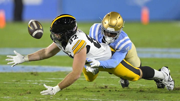 Nov 8, 2024; Pasadena, California, USA;   UCLA Bruins defensive back K.J. Wallace (7) defends Iowa Hawkeyes tight end Johnny Pascuzzi (82) forcing an incomplete pass in the first half at the Rose Bowl. Mandatory Credit: Jayne Kamin-Oncea-Imagn Images