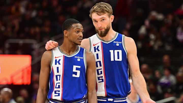 Jan 14, 2024; Milwaukee, Wisconsin, USA;  Sacramento Kings guard De'Aaron Fox (5) and center Domantas Sabonis (10) talk during a timeout in the third quarter against the Milwaukee Bucks at Fiserv Forum. Mandatory Credit: Benny Sieu-Imagn Images