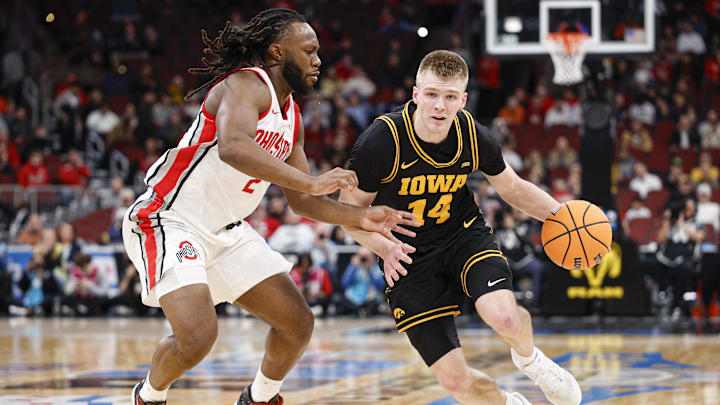 Mar 12, 2026; Chicago, IL, USA; Iowa Hawkeyes guard Bennett Stirtz (14) drives to the basket against Ohio State Buckeyes guard Bruce Thornton (2) during the first half at United Center. Mandatory Credit: Kamil Krzaczynski-Imagn Images