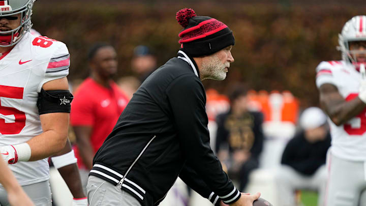 Ohio State Buckeyes defensive coordinator Jim Knowles warms up players prior to the NCAA football game against the Northwestern Wildcats at Wrigley Field in Chicago on Monday, Nov. 18, 2024. Ohio State won 31-7.