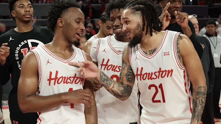 Jan 15, 2025; Houston, Texas, USA; From left to right Houston Cougars guard L.J. Cryer (4) guard Kordelius Jefferson (0) and  guard Emanuel Sharp (21) celebrate after defeating the West Virginia Mountaineers in the second half at Fertitta Center. Mandatory Credit: Thomas Shea-Imagn Images