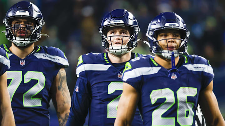 Dec 18, 2023; Seattle, Washington, USA; Seattle Seahawks quarterback Drew Lock (2), offensive tackle Abraham Lucas (72) and running back Zach Charbonnet (26) watch a replay of an intentional grounding penalty against Lock during the second quarter against the Philadelphia Eagles at Lumen Field.