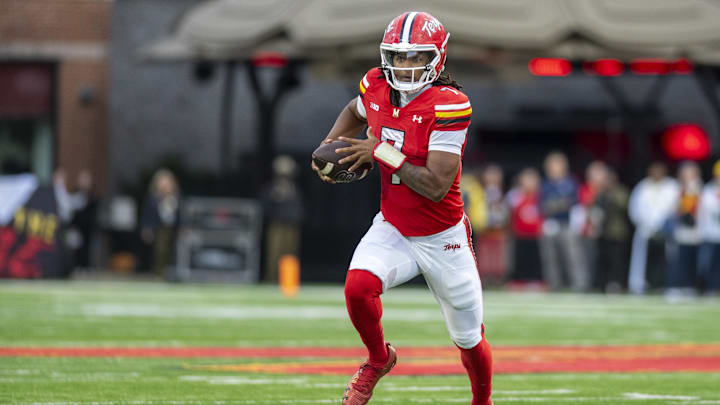 Nov 22, 2025; College Park, Maryland, USA;  Maryland Terrapins quarterback Malik Washington (7) scrambles during the first quarter against the Michigan Wolverines at SECU Stadium. Mandatory Credit: Tommy Gilligan-Imagn Images