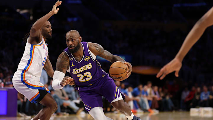 Feb 9, 2026; Los Angeles, California, USA;  Los Angeles Lakers forward LeBron James (23) drives to the basket against Oklahoma City Thunder guard Cason Wallace (22) during the third quarter at Crypto.com Arena. Mandatory Credit: Kiyoshi Mio-Imagn Images