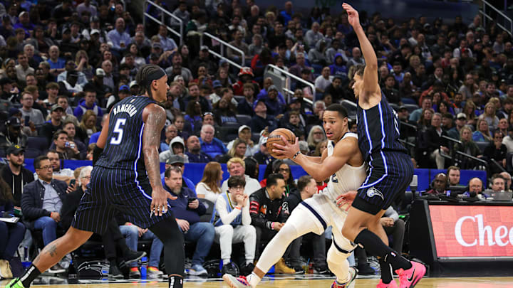 Feb 21, 2025; Orlando, Florida, USA; Memphis Grizzlies guard Desmond Bane (22) drives past Orlando Magic forward Tristan da Silva (23) during the second half at Kia Center. Mandatory Credit: Mike Watters-Imagn Images