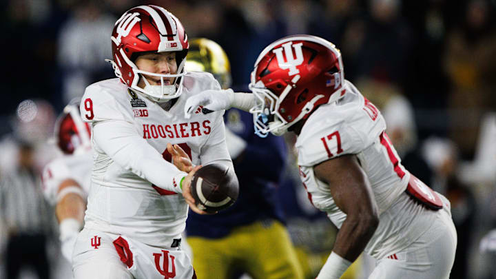 Indiana quarterback Kurtis Rourke (9) hands the ball off to running back Ty Son Lawton (17) during the first round of the College Football Playoff between Notre Dame and Indiana at Notre Dame Stadium on Friday, Dec. 20, 2024, in South Bend.