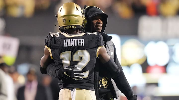 Oct 13, 2023; Boulder, Colorado, USA; Colorado Buffaloes wide receiver Travis Hunter (12) is congratulated for his touchdown by head coach Deion Sanders in the first quarter against the Stanford Cardinal at Folsom Field. 