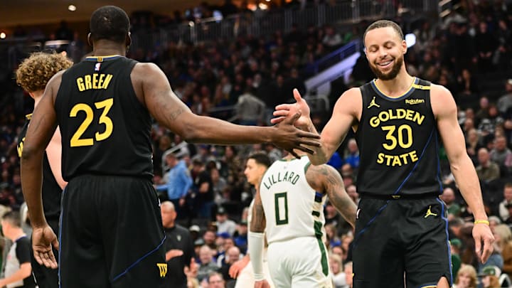 Feb 10, 2025; Milwaukee, Wisconsin, USA; Golden State Warriors guard Stephen Curry (30) celebrates with forward Draymond Green (23) in the fourth quarter against the Milwaukee Bucks at Fiserv Forum. Mandatory Credit: Benny Sieu-Imagn Images