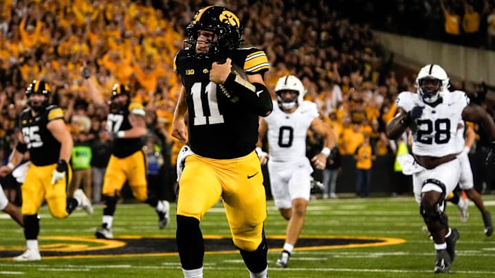 Iowa Hawkeyes quarterback Mark Gronowski (11) carries the ball down field during a college football game against the Penn State Nittany Lions Oct. 18, 2025 at Kinnick Stadium in Iowa City, Iowa.