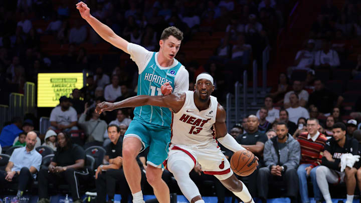 Oct 28, 2025; Miami, Florida, USA; Miami Heat center Bam Adebayo (13) drives to the basket against Charlotte Hornets center Ryan Kalkbrenner (11) during the fourth quarter at Kaseya Center. Mandatory Credit: Sam Navarro-Imagn Images