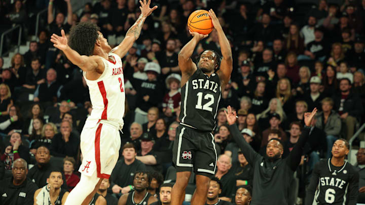 Jan 29, 2025; Starkville, Mississippi, USA; Mississippi State Bulldogs guard Josh Hubbard (12) shoots as Alabama Crimson Tide guard Aden Holloway (2) defends during the second half at Humphrey Coliseum. Mandatory Credit: Wesley Hale-Imagn Images