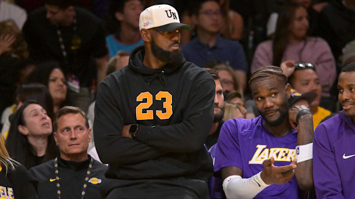 Oct 12, 2025; Los Angeles, California, USA;  Los Angeles Lakers forward LeBron James (23) looks on from the bench during the first half against the Golden State Warriors at Crypto.com Arena. Mandatory Credit: Jayne Kamin-Oncea-Imagn Images