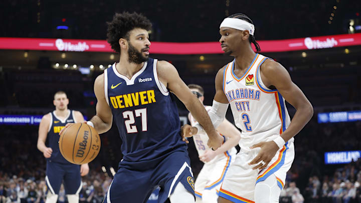 Mar 10, 2025; Oklahoma City, Oklahoma, USA;Denver Nuggets guard Jamal Murray (27) drives against Oklahoma City Thunder guard Shai Gilgeous-Alexander (2) during the second quarter at Paycom Center. Mandatory Credit: Alonzo Adams-Imagn Images