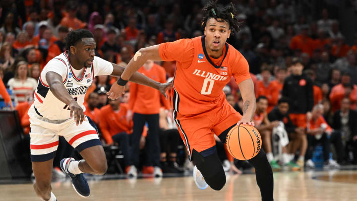 Mar 30, 2024; Boston, MA, USA; Illinois Fighting Illini guard Terrence Shannon Jr. (0) dribbles the ball against Connecticut Huskies guard Hassan Diarra (10) in the finals of the East Regional of the 2024 NCAA Tournament at TD Garden. Mandatory Credit: Brian Fluharty-USA TODAY Sports