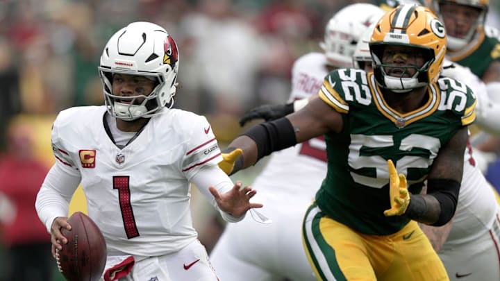 Arizona Cardinals' Kyler Murray (1) eludes Green Bay Packers defensive end Rashan Gary (52) during the third quarter of their game Sunday, October 13, 2024 at Lambeau Field in Green Bay, Wisconsin. The Green Bay Packers beat the Arizona Cardinals 34-13.