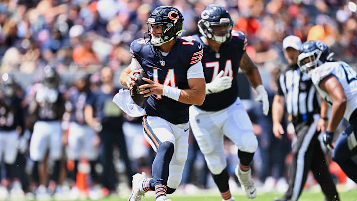 Aug 12, 2023; Chicago, Illinois, USA;  Chicago Bears quarterback Nathan Peterman (14) runs in the second half against the Tennessee Titans at Soldier Field.