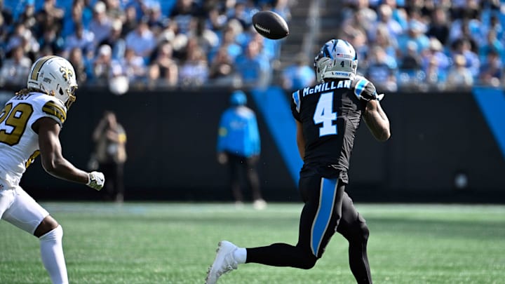Nov 9, 2025; Charlotte, North Carolina, USA;  Carolina Panthers wide receiver Tetairoa McMillan (4) catches a pass as New Orleans Saints cornerback Quincy Riley (29) defends in the first quarter at Bank of America Stadium. Mandatory Credit: Bob Donnan-Imagn Images