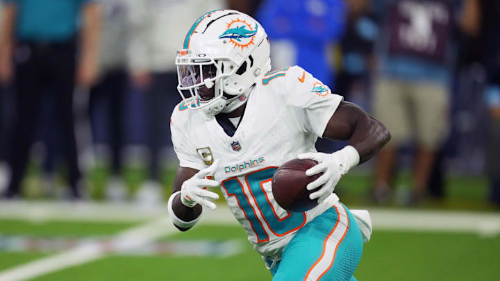 Nov 11, 2024; Inglewood, California, USA; Miami Dolphins wide receiver Tyreek Hill (10) carries the ball against the Los Angeles Rams in the second half at SoFi Stadium. Mandatory Credit: Kirby Lee-Imagn Images