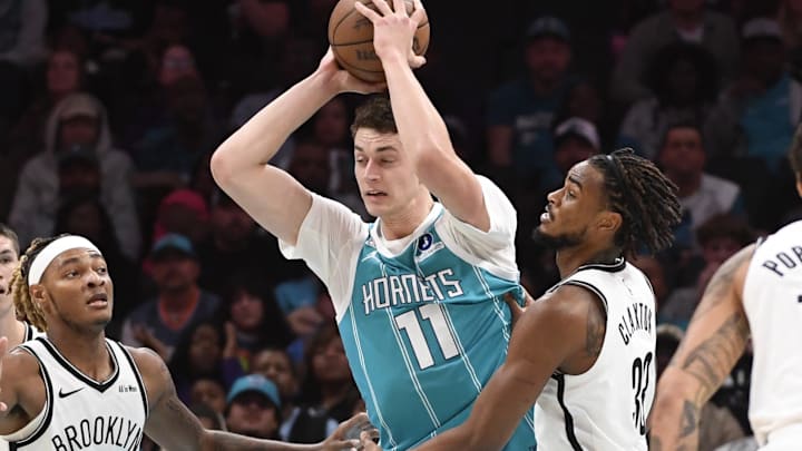 Oct 22, 2025; Charlotte, North Carolina, USA;  Charlotte Hornets center Ryan Kalkbrenner (11) looks to pass during the first half against the Brooklyn Nets at the Spectrum Center. Mandatory Credit: Sam Sharpe-Imagn Images