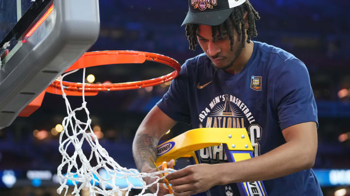 Connecticut Huskies guard Stephon Castle (5) cuts the basketball net after winning the Men's NCAA national championship game against the Purdue Boilermakers at State Farm Stadium in Glendale on April 8, 2024.