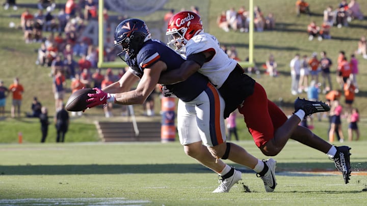 Oct 12, 2024; Charlottesville, Virginia, USA; Virginia Cavaliers tight end Tyler Neville (16) catches a pass as Louisville Cardinals defensive back Tamarion McDonald (12) defends during the first half at Scott Stadium. Mandatory Credit: Amber Searls-Imagn Images