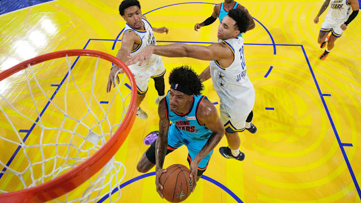 February 14, 2025; San Francisco, California, USA; Team G-League guard Dink Pate (1) of the Mexico City Capitanes drives to the basket against Team C forward Ryan Dunn (0) of the Phoenix Suns and forward Trayce Jackson-Davis (32) of the Golden State Warriors during the 2025 NBA Rising Stars Game at Chase Center. Mandatory Credit: Kyle Terada-Imagn Images