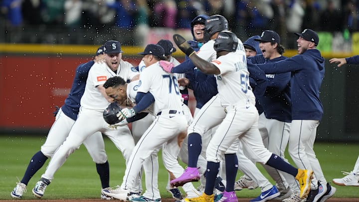 Oct 10, 2025; Seattle, Washington, USA; Seattle Mariners second baseman Jorge Polanco (7) celebrates with teammates after hitting a walk off single against the Detroit Tigers during the fifteenth inning during game five of the ALDS round for the 2025 MLB playoffs at T-Mobile Park. Mandatory Credit: Stephen Brashear-Imagn Images Oct 10, 2025; Seattle, Washington, USA; Seattle Mariners second baseman Jorge Polanco (7) celebrates with teammates after hitting a walk off single against the Detroit Tigers during the fifteenth inning during game five of the ALDS round for the 2025 MLB playoffs at T-Mobile Park. Mandatory Credit: Stephen Brashear-Imagn Images