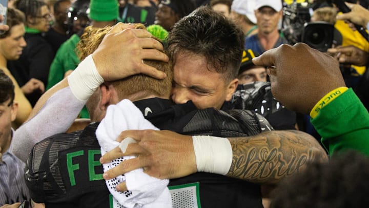 Oregon quarterback Dillon Gabriel celebrates with Terrance Ferguson and Duck fans after defeating Ohio State 32-31 at Autzen Stadium Saturday, Oct. 12, 2024.