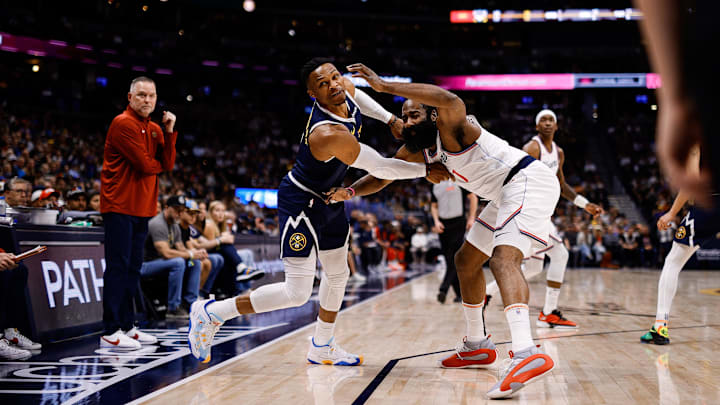 Denver Nuggets guard Russell Westbrook (4) and Los Angeles Clippers guard James Harden (1) battle for the ball in the first quarter at Ball Arena. 