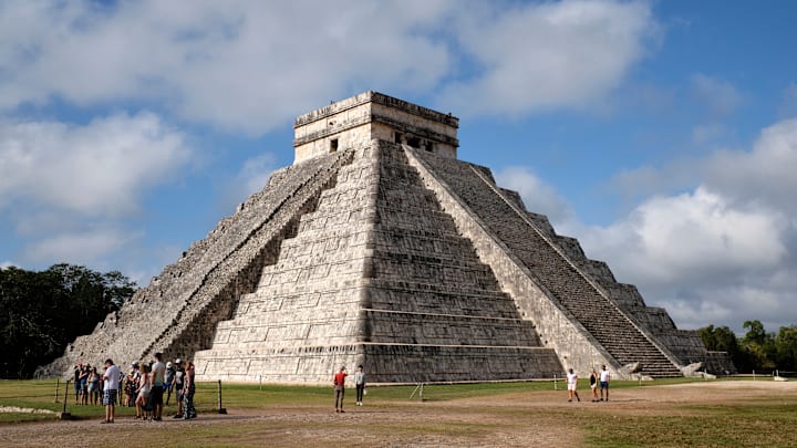 Tourists visiting the pyramids of the Chichen Itza...