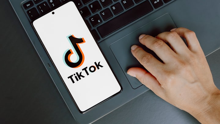 In this photo illustration, the TikTok logo is displayed on...