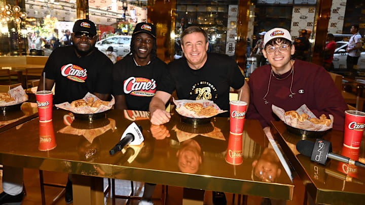 BOSTON, MASSACHUSETTS - AUGUST 28: David Ortiz, Jrue Holiday and Todd Graves attend the celebration of Raising Cane's "Golden Birthday" with opening of new gold restaurant on August 28, 2024 in Boston, Massachusetts. (Photo by Dave Kotinsky/Getty Images for Raising Cane's)
