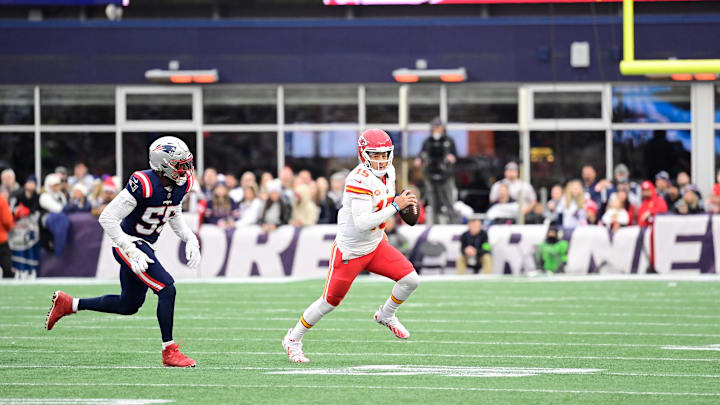 Dec 17, 2023; Foxborough, Massachusetts, USA; Kansas City Chiefs quarterback Patrick Mahomes (15) scrambles as New England Patriots linebacker Josh Uche (55) chases him during the second half at Gillette Stadium. Mandatory Credit: Eric Canha-Imagn Images