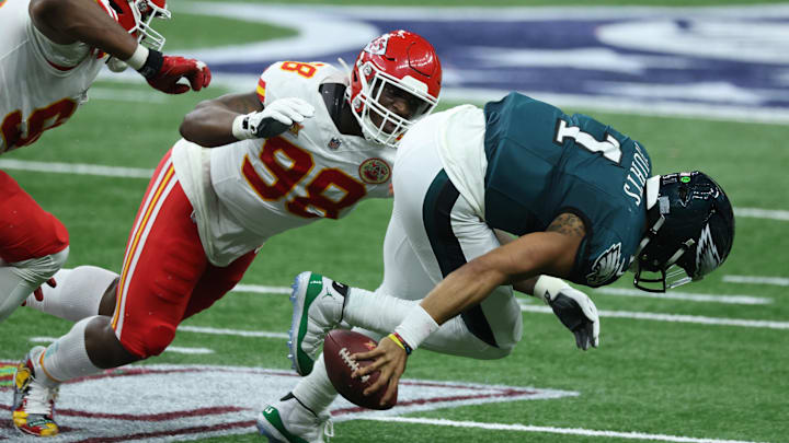 Feb 9, 2025; New Orleans, LA, USA; Philadelphia Eagles quarterback Jalen Hurts (1) is tackled by Kansas City Chiefs defensive tackle Tershawn Wharton (98) in the second quarter in Super Bowl LIX at Ceasars Superdome. Mandatory Credit: Stephen Lew-Imagn Images